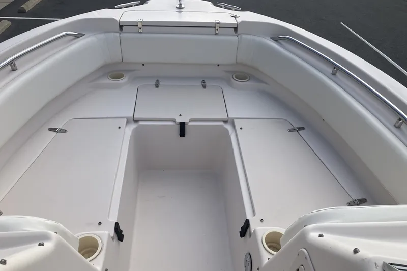 Slide: The Image of 2005 Grady-White Tournament 225 boat interior with white seating and storage compartments. - 11