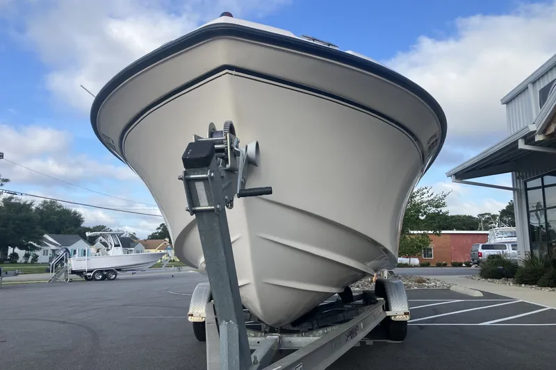 Slide: The Image of 2005 Grady-White Tournament 225 boat on trailer, parked outdoors under a blue sky. - 3
