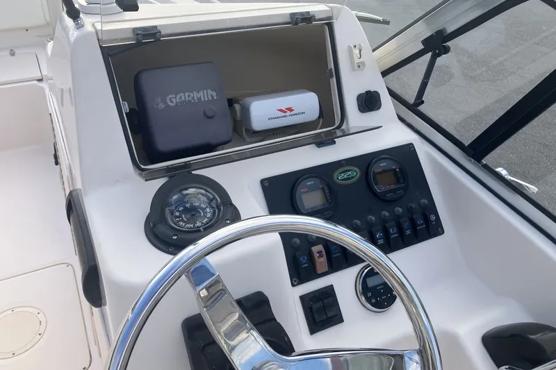 Slide: The Image of 2005 Grady-White Tournament 225 boat dashboard with Garmin navigation and compass. - 12
