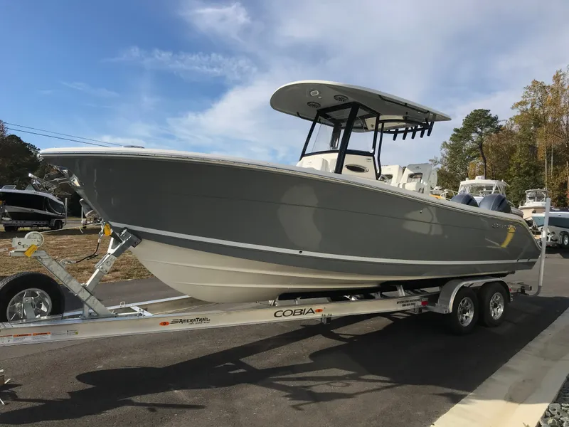 The Image of A gray 2020 Cobia 262 Center Console boat on a trailer, ready for transport. - 0