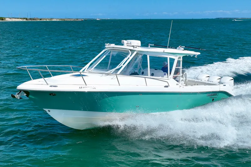 The Image of A 2016 Everglades 350LX boat speeding across the blue water. - 0