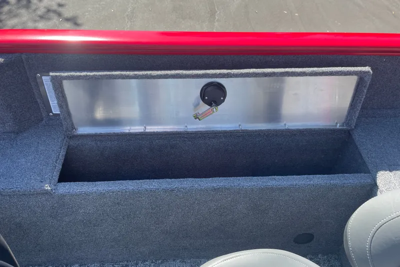 Slide: The Image of 2026 Tracker Pro Guide V-175 WT boat interior storage compartment with gray carpeting. - 16