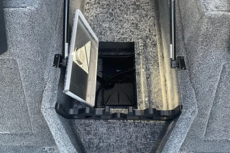 Slide: The Image of 2026 Tracker Pro Guide V-175 WT boat storage compartment with open hatch and carpeted interior. - 13