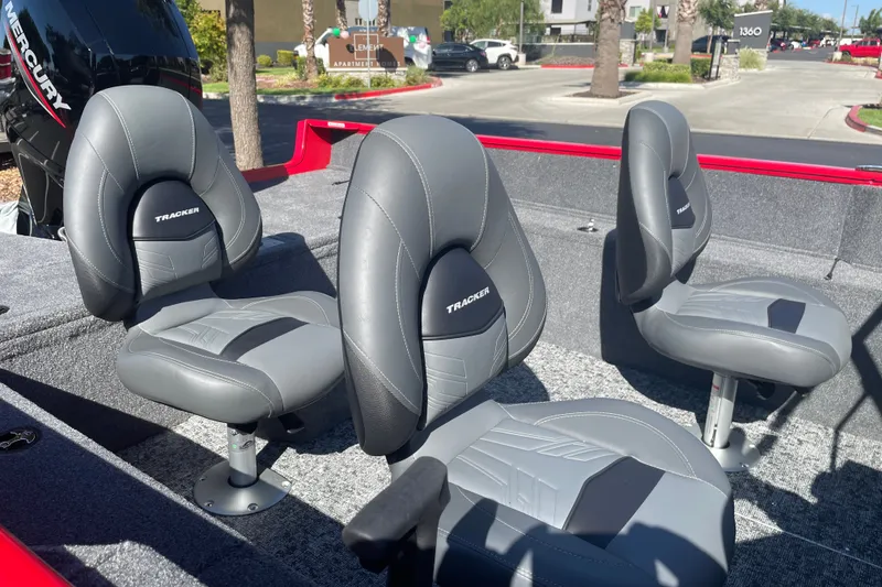Slide: The Image of 2026 Tracker Pro Guide V-175 WT boat interior with four gray seats and Mercury engine. - 19