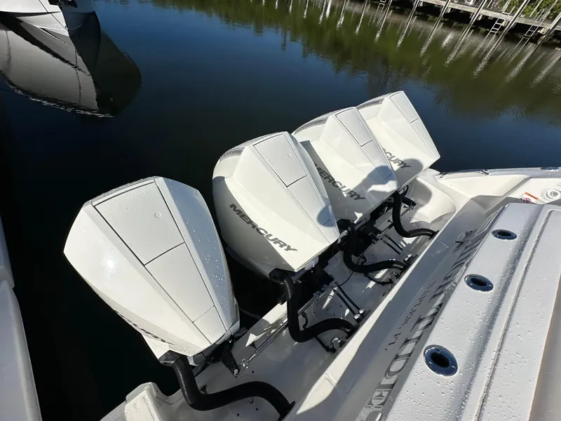 Slide: The Image of Four Mercury outboard engines on a 2022 Boston Whaler 380 Realm boat. - 11