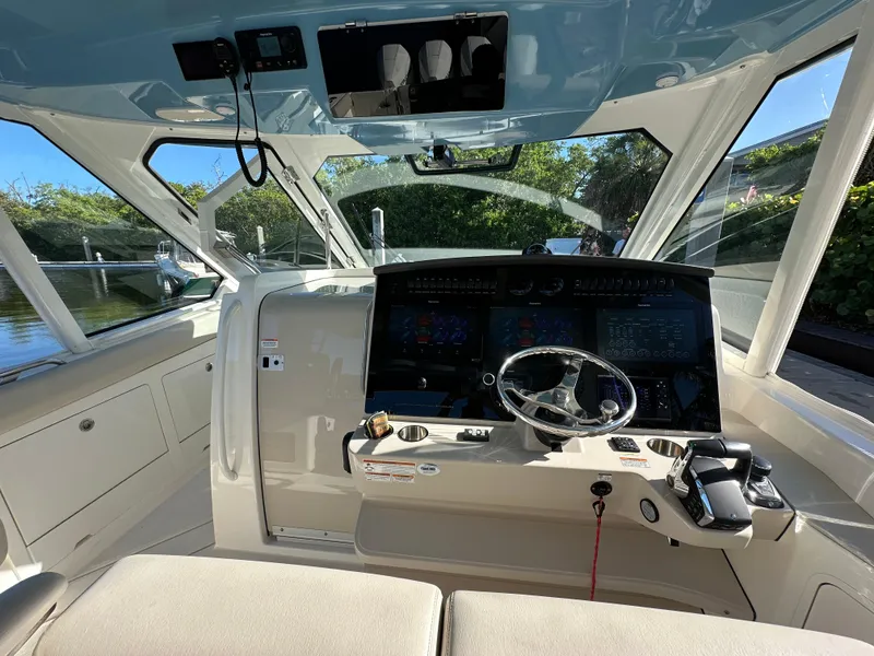 Slide: The Image of 2022 Boston Whaler 380 Realm cockpit with modern controls and steering wheel. - 19