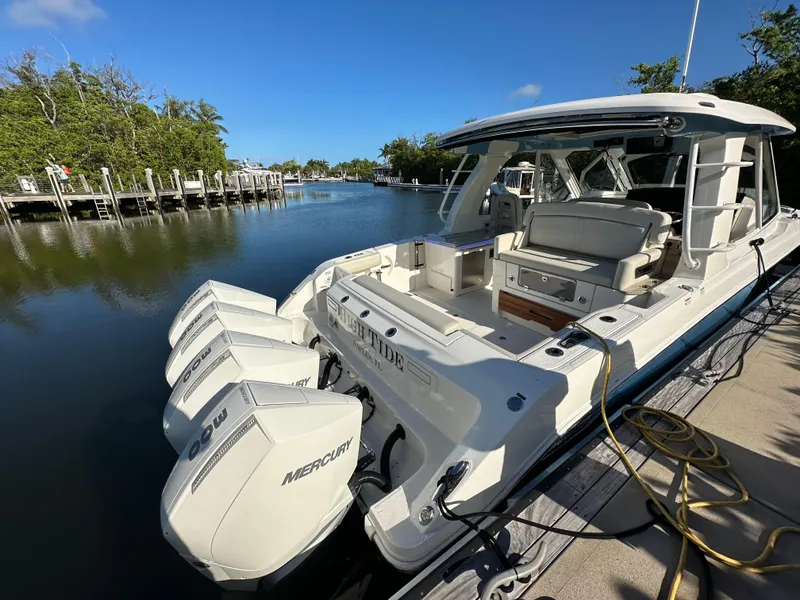Slide: The Image of 2022 Boston Whaler 380 Realm docked, featuring powerful Mercury outboard engines. - 4