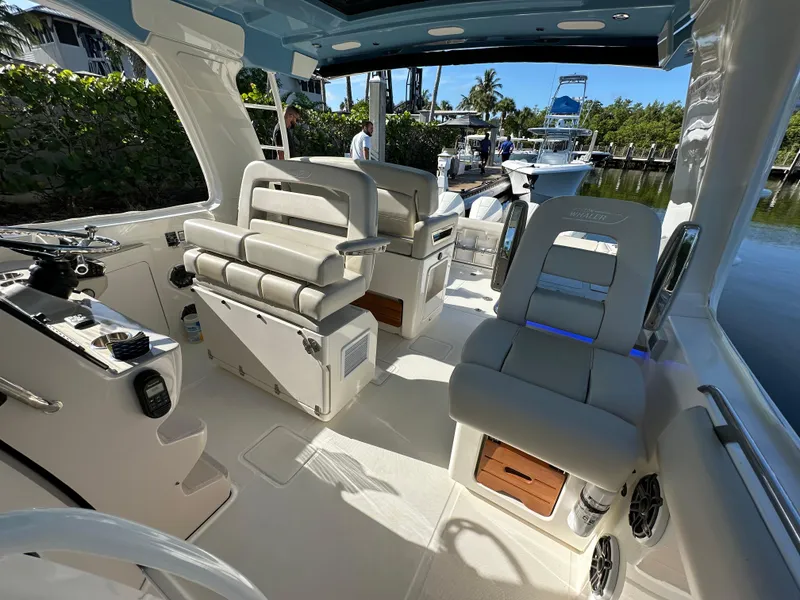 Slide: The Image of Interior of 2022 Boston Whaler 380 Realm boat, featuring luxurious seating and modern controls. - 25