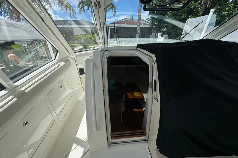Slide: The Image of 2022 Boston Whaler 380 Realm cabin entrance with sleek interior and outdoor view. - 47