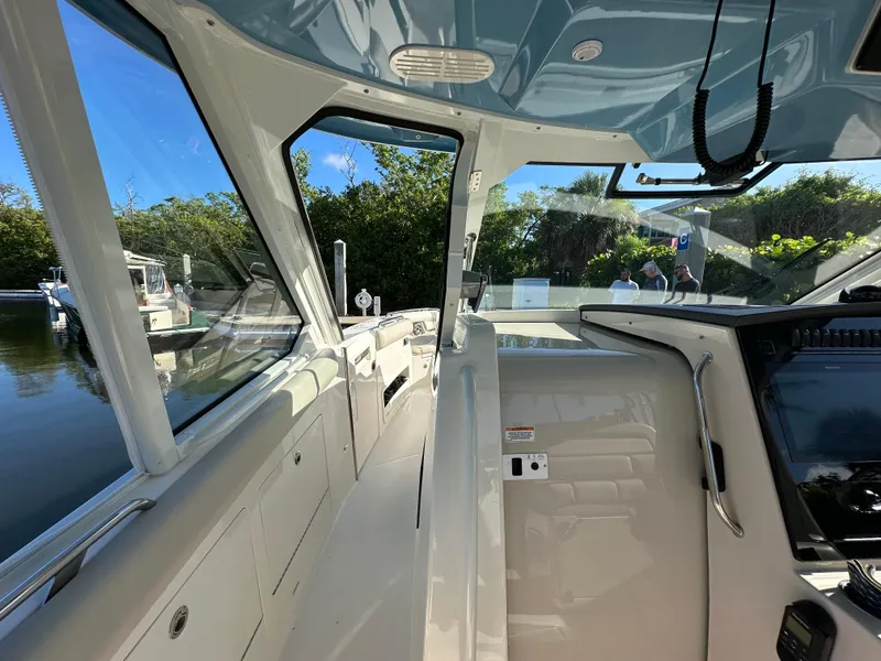 Slide: The Image of Interior view of 2022 Boston Whaler 380 Realm boat, showcasing helm and seating area. - 20