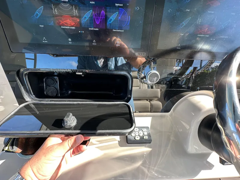Slide: The Image of Dashboard of 2022 Boston Whaler 380 Realm with touchscreen controls and storage compartment. - 27