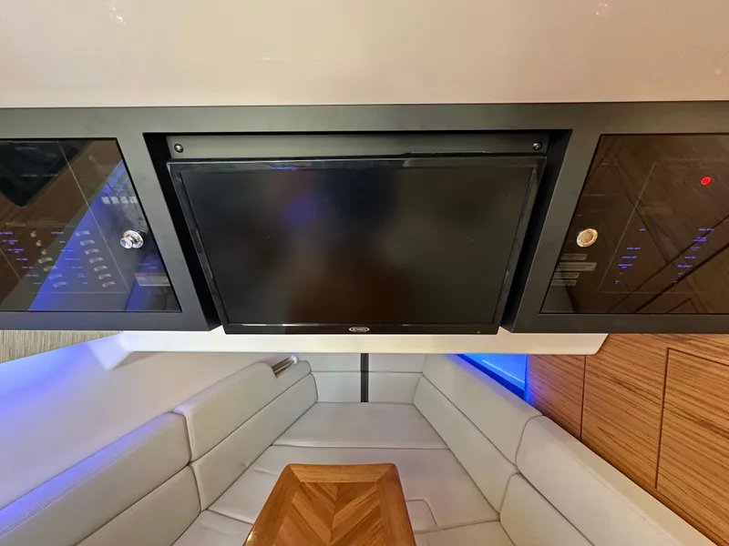 Slide: The Image of 2022 Boston Whaler 380 Realm interior with TV and seating area. - 31