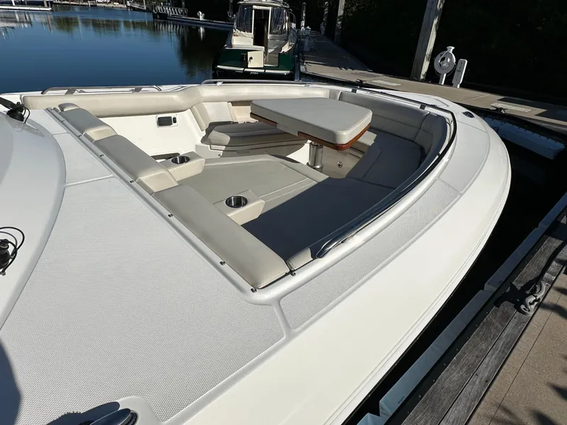 Slide: The Image of 2022 Boston Whaler 380 Realm boat with spacious seating and table on deck. - 8