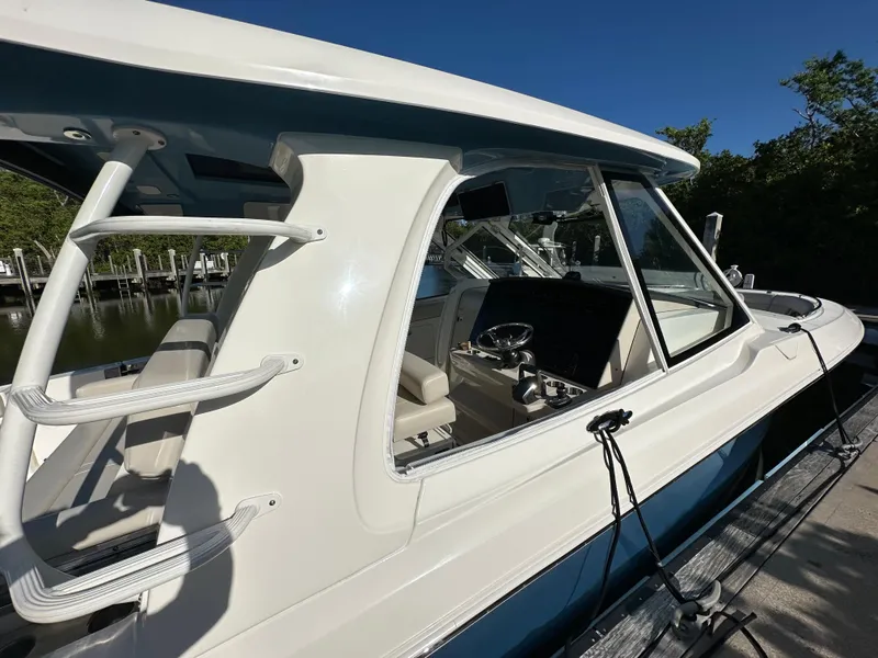 Slide: The Image of 2022 Boston Whaler 380 Realm boat docked, showcasing sleek design and modern features. - 10
