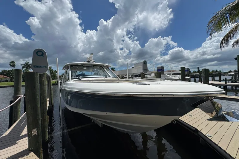 Slide: The Image of 2022 Boston Whaler 380 Realm docked under a partly cloudy sky. - 44