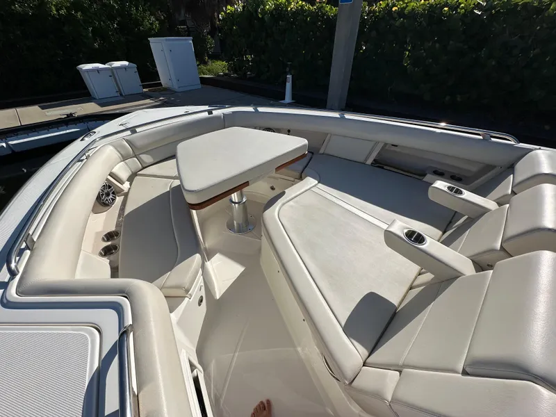 Slide: The Image of 2022 Boston Whaler 380 Realm boat interior with cushioned seating and table. - 22