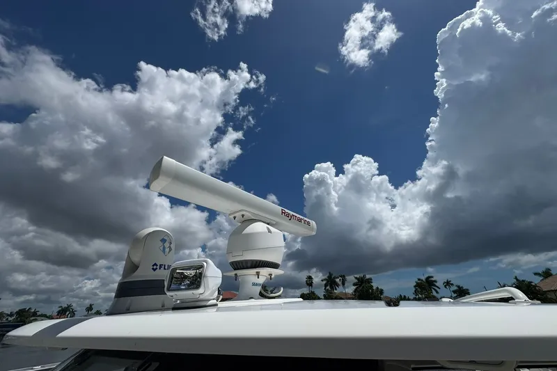 Slide: The Image of Radar equipment on a 2022 Boston Whaler 380 Realm under a cloudy sky. - 12