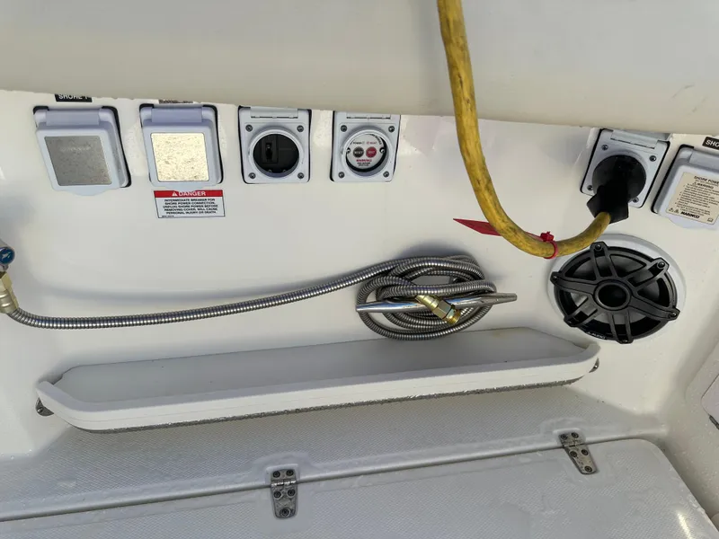 Slide: The Image of Boston Whaler 380 Realm 2022 boat electrical panel with shore power connections and speaker. - 39