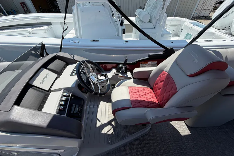 Slide: The Image of 2023 Bennington 23 LX boat interior with Garmin navigation and luxurious seating. - 18