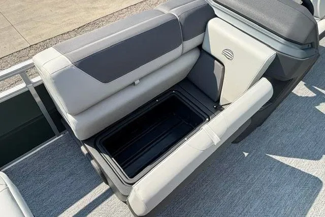 Slide: The Image of 2026 Sun Tracker Fishin' Barge 22 DLX boat seat with open storage compartment. - 13