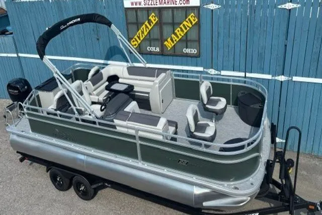The Image of 2026 Sun Tracker Fishin' Barge 22 DLX pontoon boat on trailer, parked at Sizzle Marine. - 0