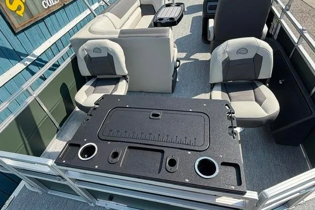 Slide: The Image of 2026 Sun Tracker Fishin' Barge 22 DLX interior with seating and fishing station. - 22
