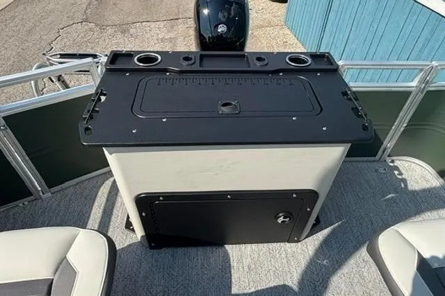 Slide: The Image of 2026 Sun Tracker Fishin' Barge 22 DLX boat deck with storage and seating. - 20