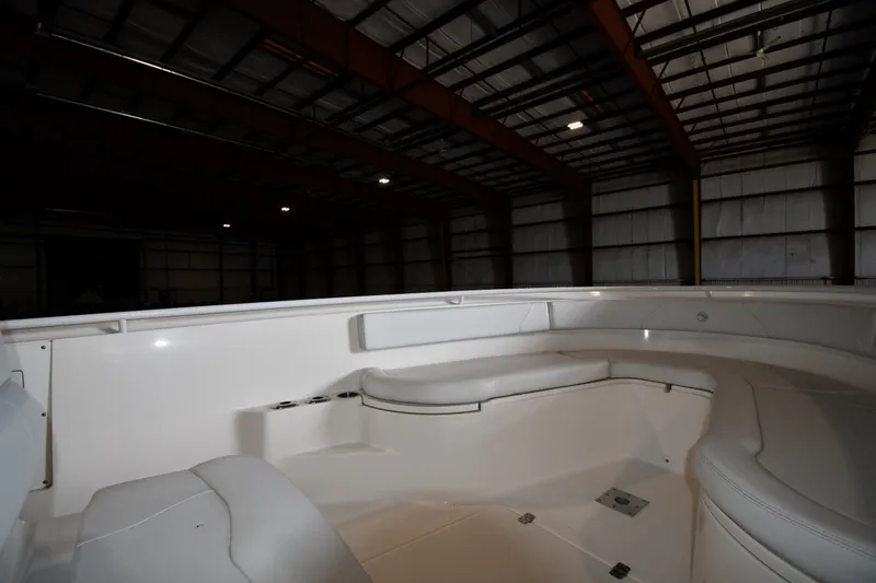 Slide: The Image of 2015 Edgewater 320CC boat interior in a dimly lit warehouse. - 22
