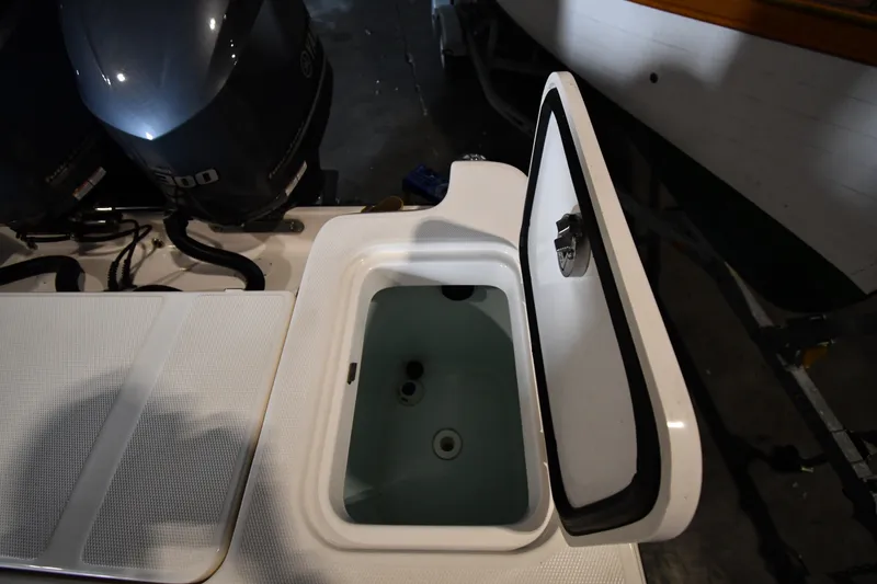 Slide: The Image of Open storage compartment on a 2015 Edgewater 320CC boat, showcasing interior space. - 33