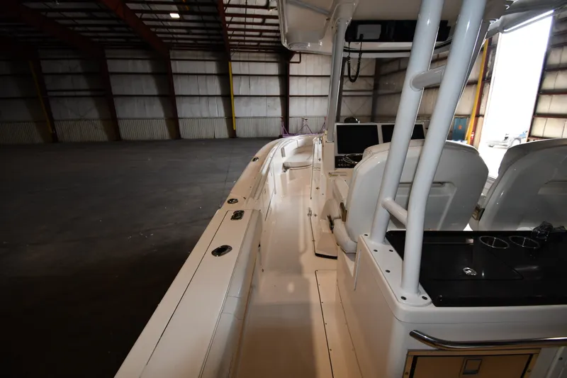 Slide: The Image of 2015 Edgewater 320CC boat interior in a spacious warehouse setting. - 20
