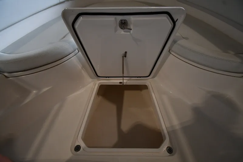 Slide: The Image of Open storage compartment on 2015 Edgewater 320CC boat, showcasing interior space. - 36