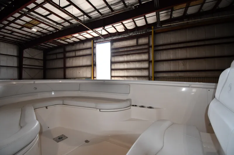 Slide: The Image of Interior view of 2015 Edgewater 320CC boat in a warehouse setting. - 21