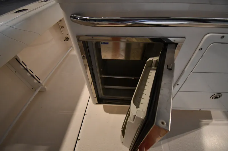Slide: The Image of Open storage compartment on 2015 Edgewater 320CC boat interior. - 17