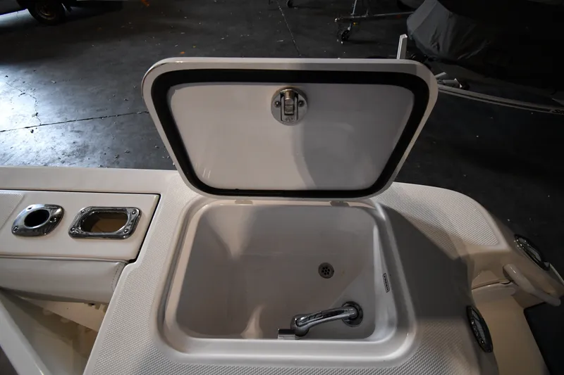 Slide: The Image of Open storage compartment on a 2015 Edgewater 320CC boat, showcasing interior details. - 31