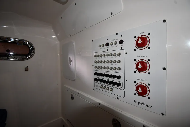 Slide: The Image of Electrical panel inside 2015 Edgewater 320CC boat, featuring switches and engine controls. - 38
