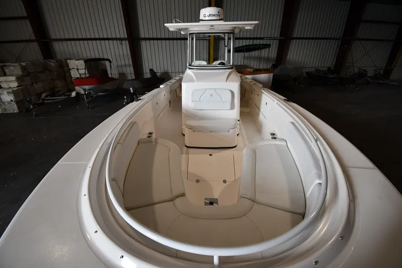 Slide: The Image of 2015 Edgewater 320CC boat interior with seating and Garmin equipment in a warehouse setting. - 27