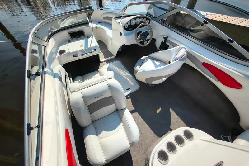 Slide: The Image of 2004 Stingray 185 LS/LX boat interior with white seating and modern dashboard. - 3