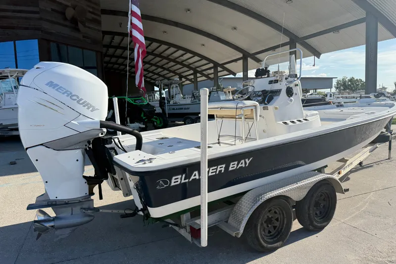 Slide: The Image of 2005 Blazer Bay 2220 Fisherman boat with Mercury outboard motor on trailer. - 2