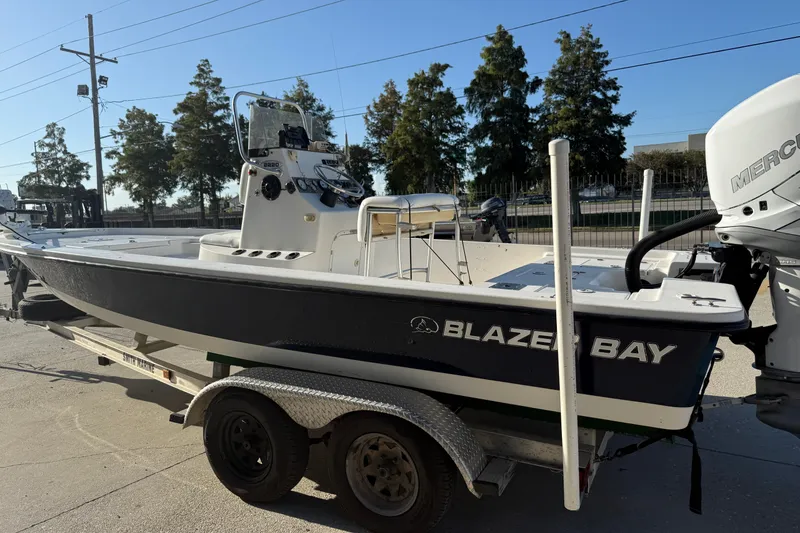 Slide: The Image of 2005 Blazer Bay 2220 Fisherman boat on trailer, parked outdoors. - 6