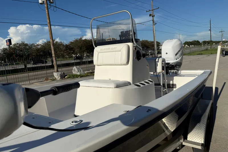 Slide: The Image of 2005 Blazer Bay 2220 Fisherman boat with Mercury engine, parked on a trailer. - 9