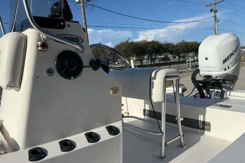 Slide: The Image of 2005 Blazer Bay 2220 Fisherman boat with Mercury engine, docked outdoors. - 11