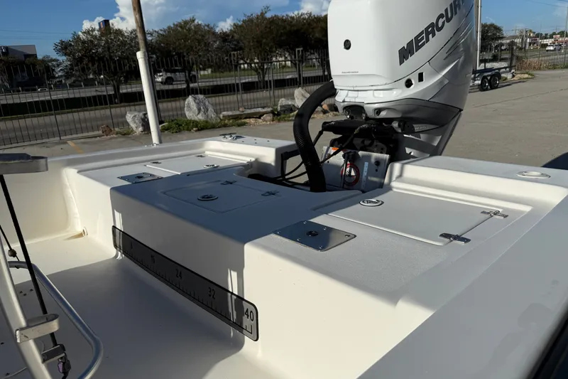 Slide: The Image of 2005 Blazer Bay 2220 Fisherman boat with Mercury engine, docked outdoors. - 13