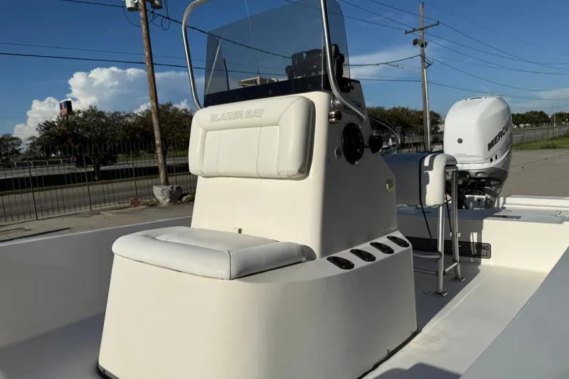 Slide: The Image of 2005 Blazer Bay 2220 Fisherman boat with console and seating, parked outdoors. - 10