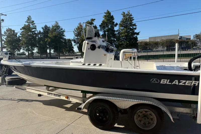 Slide: The Image of 2005 Blazer Bay 2220 Fisherman boat on trailer, parked outdoors. - 7