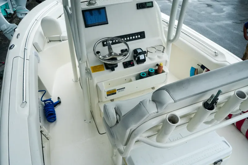Slide: The Image of 2022 Key West 219 FS boat interior with steering console and seating area. - 38