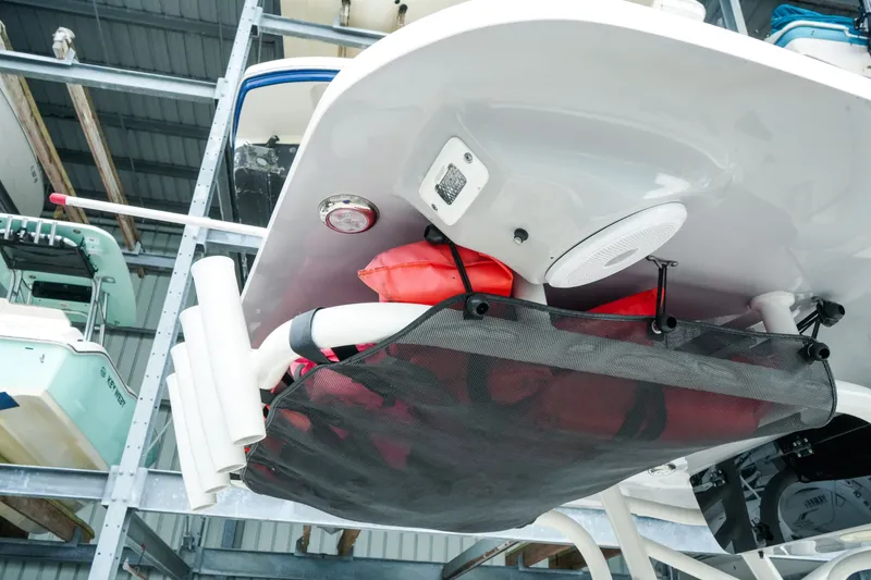 Slide: The Image of 2022 Key West 219 FS boat underside with storage net and life jackets. - 26