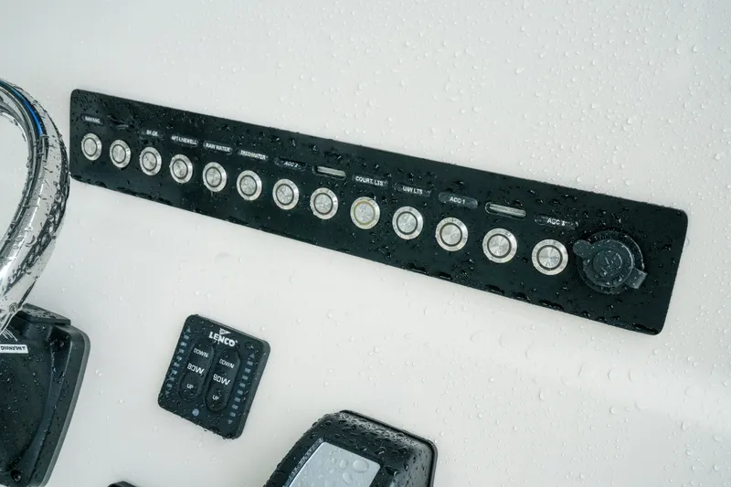Slide: The Image of Control panel of 2022 Key West 219 FS boat, featuring various switches and buttons. - 33