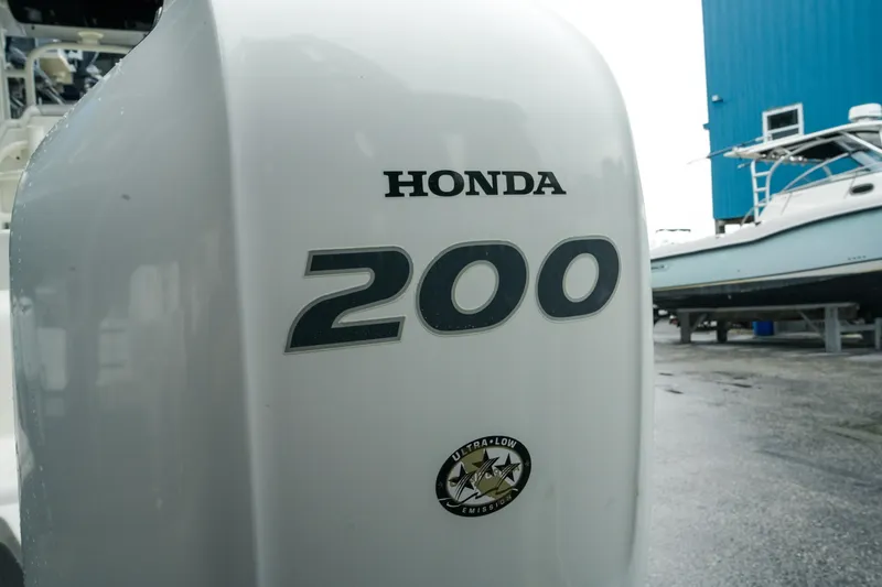 Slide: The Image of Honda 200 outboard motor on a 2022 Key West 219 FS boat, dockside view. - 39