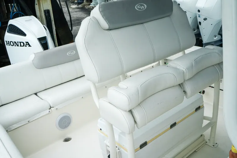 Slide: The Image of 2022 Key West 219 FS boat interior with Honda engine, featuring cushioned seating. - 34