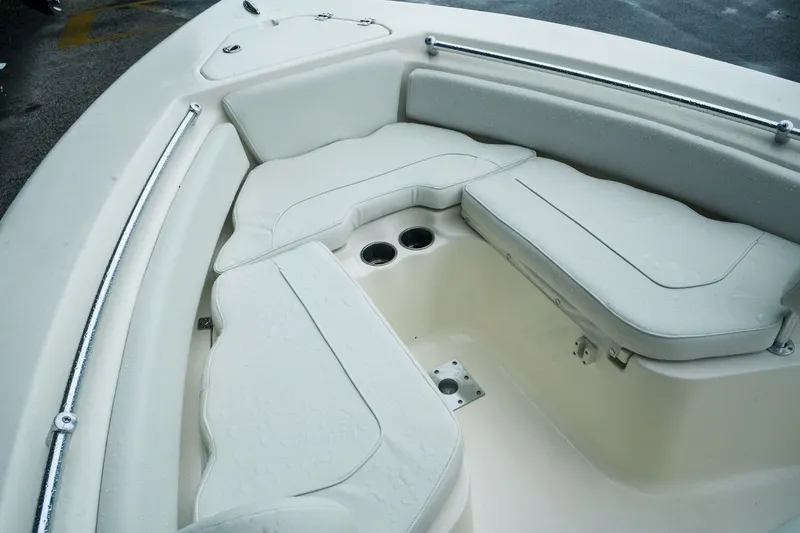 Slide: The Image of 2022 Key West 219 FS boat interior with cushioned seating and cup holders. - 15